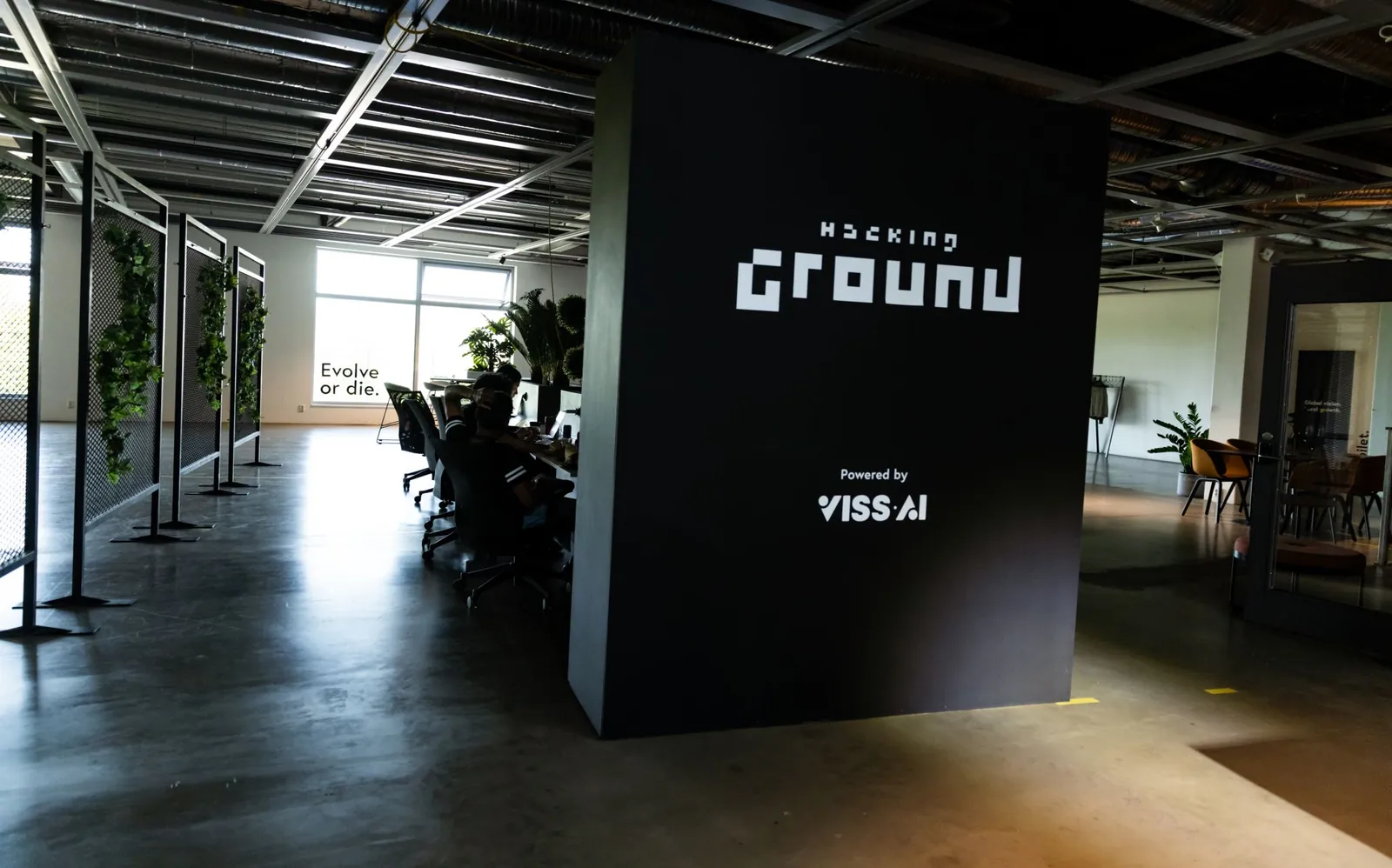 The Hacking Ground venue: the event wall with the hacking tables behind it