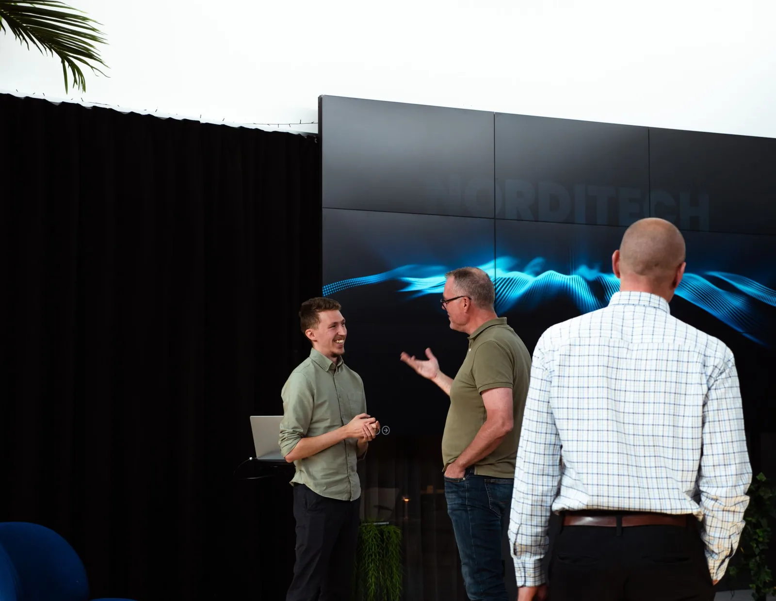 Philip talking with guests in front of the Norditech screen at GRO36